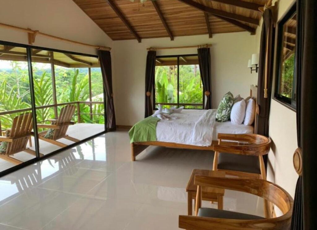 eco‑lodge bungalow bedroom with rainforest view in Drake Bay